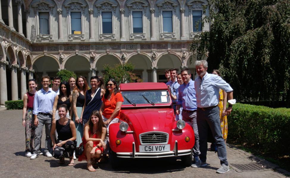 The research team posing after the arrival of the 2CV in Via Festa del Perdono, seat of the University of Milan